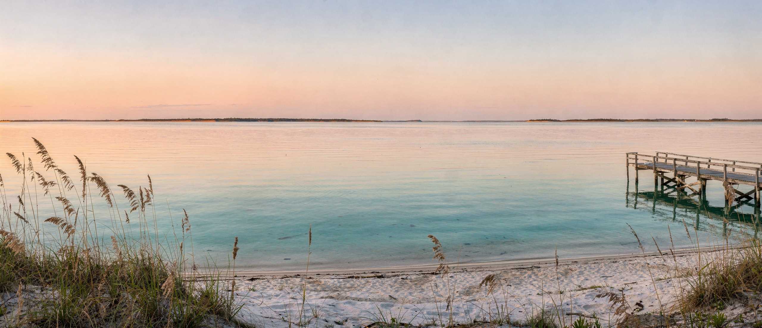 South Padre inspired coastal artwork of still bay water and a small empty pier at dusk.